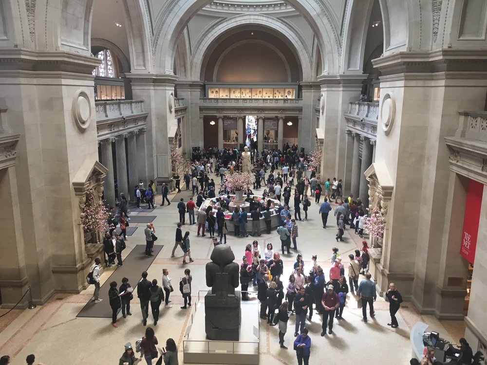 Picture inside the lobby at The Metropolitan Museum of Art filled with people