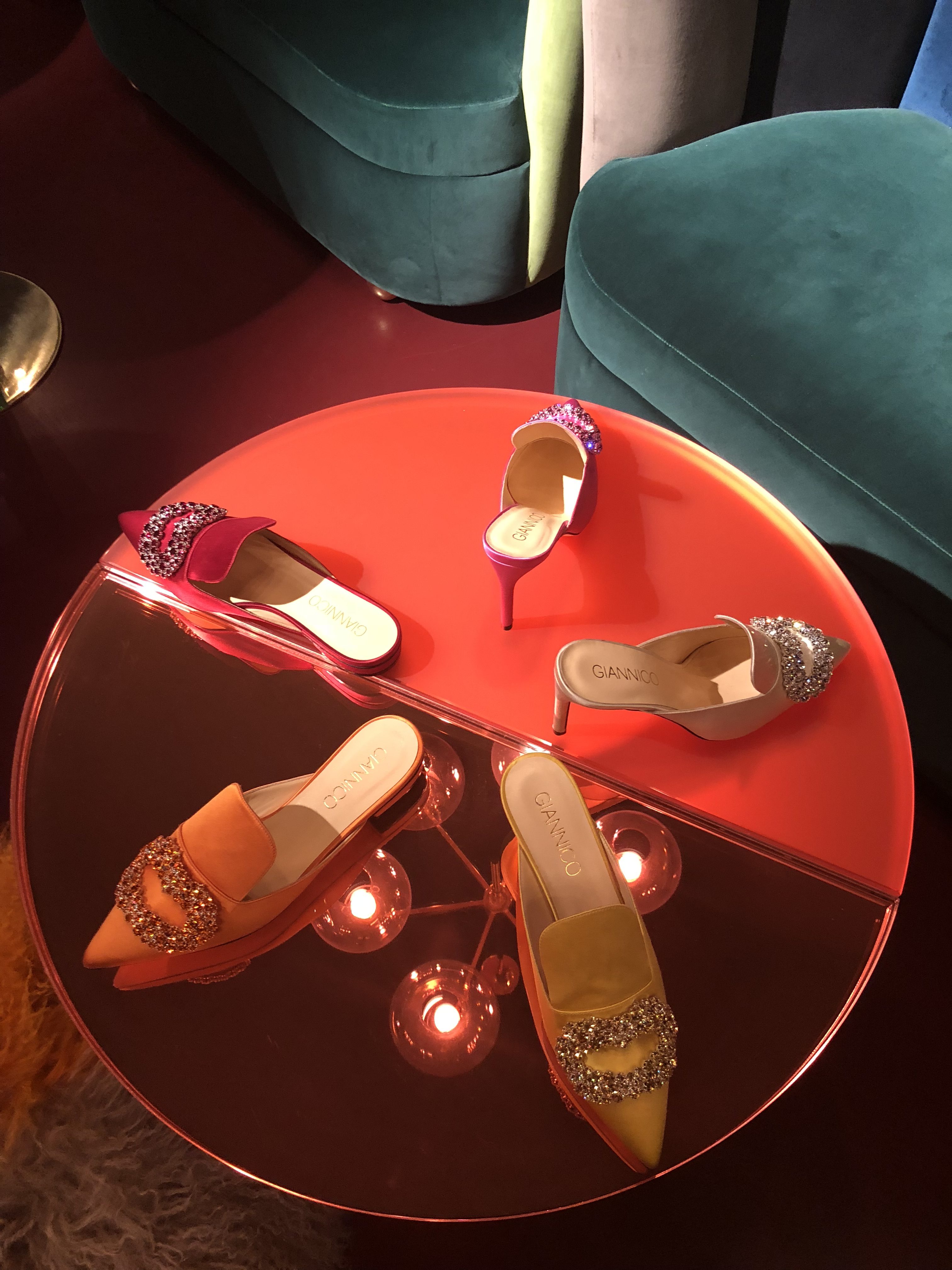 five pairs of heels with buckles sitting on a round table