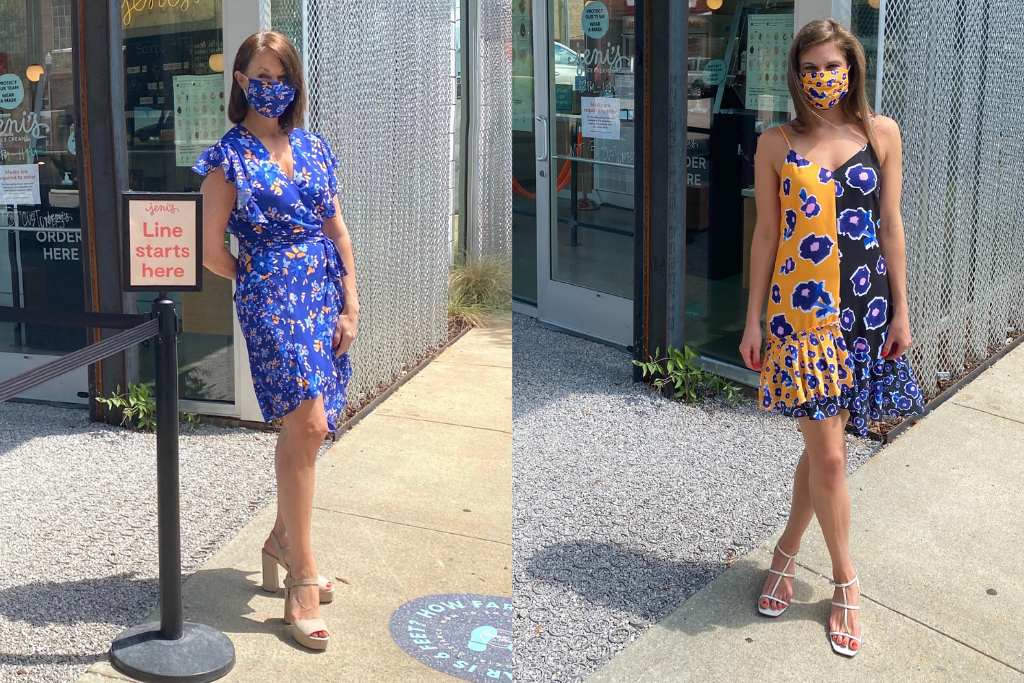Woman wearing a yellow & blue spaghetti strap dress with flowers standing in front of an ice cream store