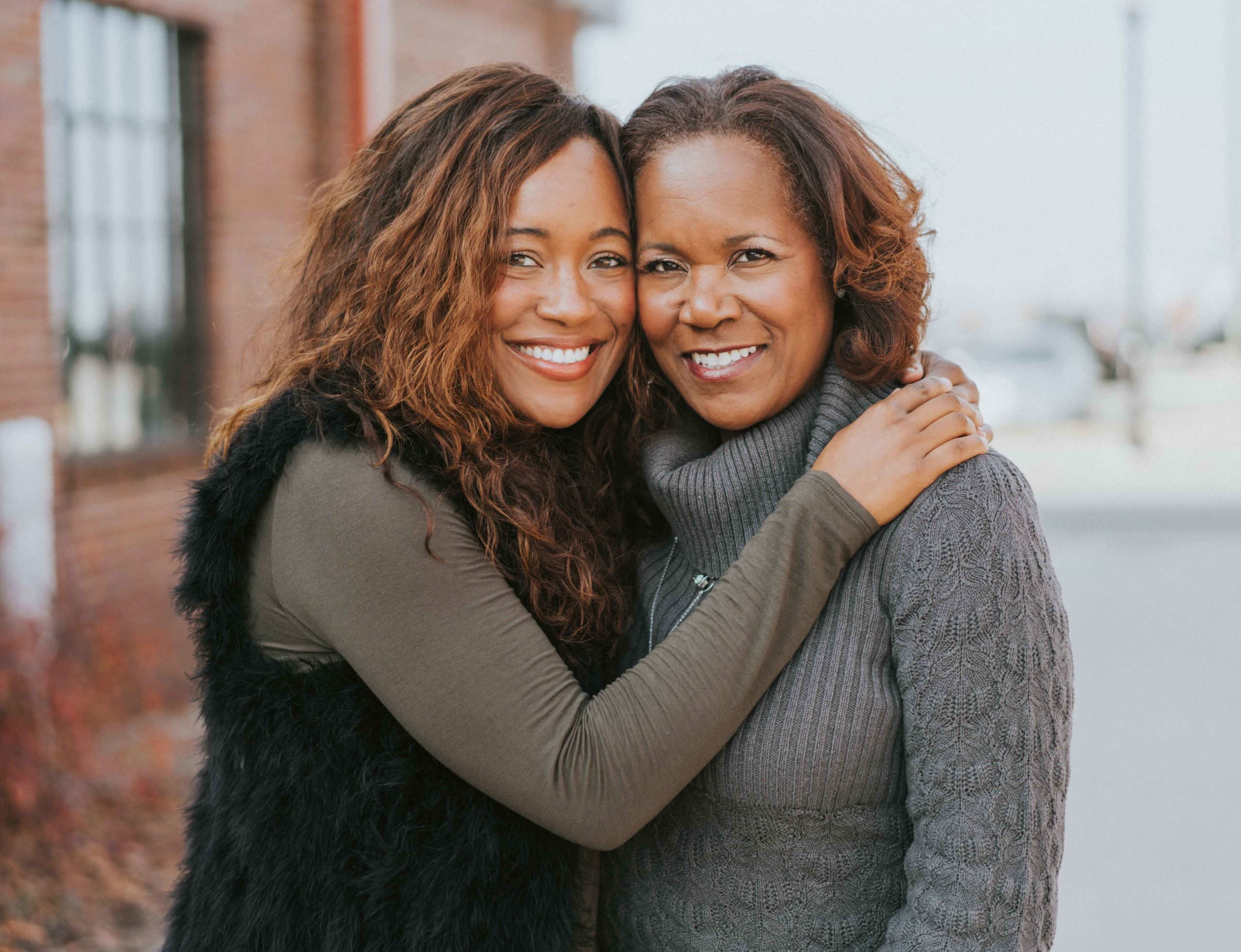 Two black women hugging and smiling