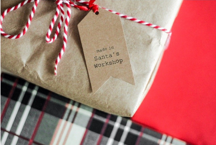Holiday gifts - brown paper with plaid & red background