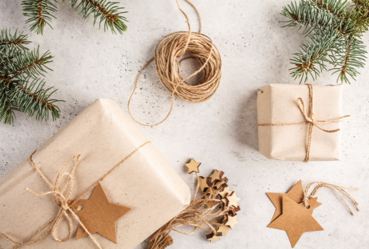 holiday gifts wrapped in brown paper on a grey background