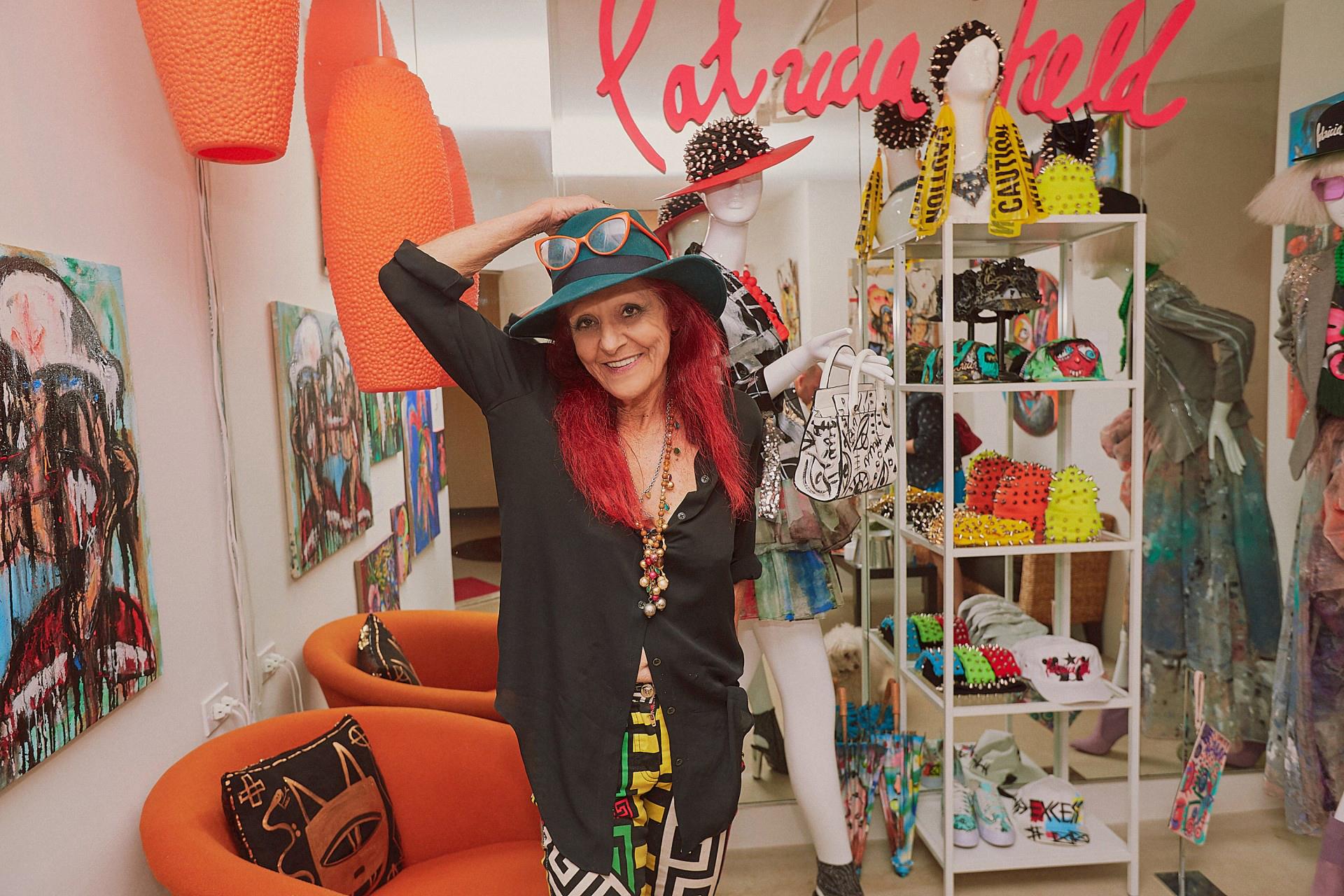 white woman with red hair standing in a colorful shop
