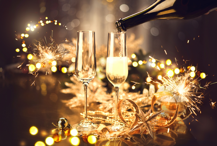 Champagne glasses being filled at a New Year's Eve celebration
