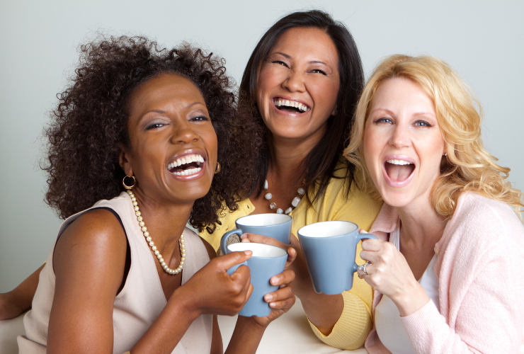 Group of women smiling & laughing looking at the camera